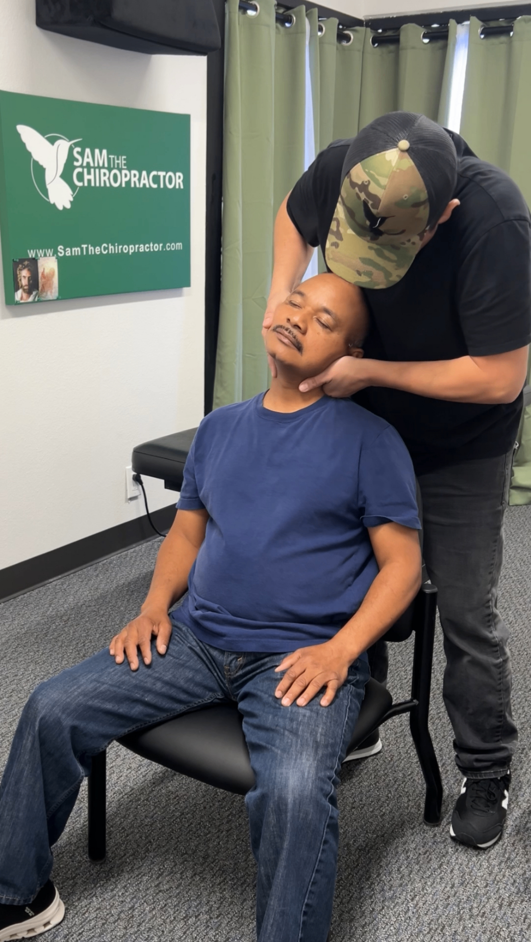 Dr. Sam adjusting a patient's neck in the seated position