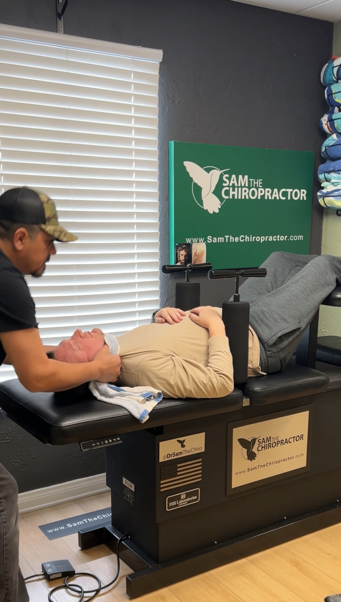 Dr. Sam adjusting a patient on the Hill Laboratories decompression table